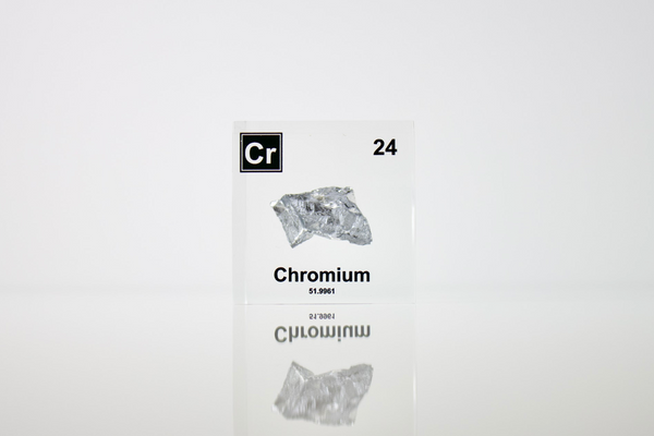 Chromium enclosed in a clear acrylic cube, highlighting its name, atomic number 24, and key properties from the periodic table. A great educational tool and collector’s piece.