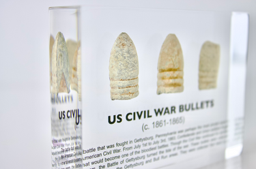 Clear acrylic display case featuring historical Civil War bullets, offering an educational presentation for collectors and enthusiasts of American history.