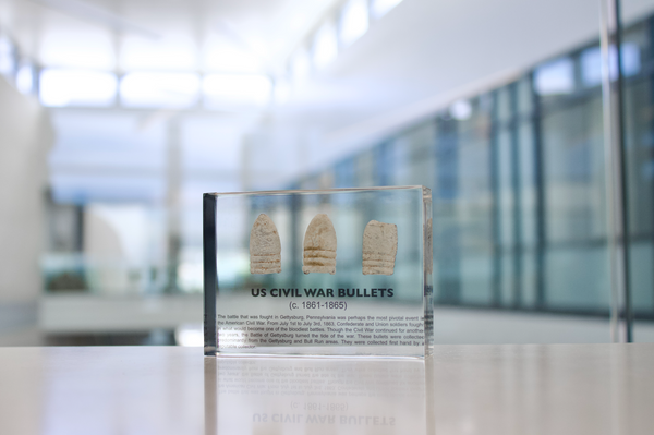 Clear acrylic display case featuring historical Civil War bullets, offering an educational presentation for collectors and enthusiasts of American history.