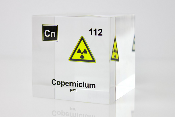 Clear acrylic cube displaying a Copernicium element (Atomic Number 112) embedded within, offering a scientific presentation for collectors and science enthusiasts.