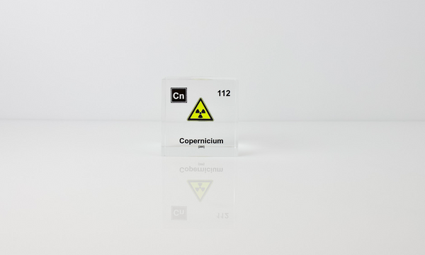 Clear acrylic cube displaying a Copernicium element (Atomic Number 112) embedded within, offering a scientific presentation for collectors and science enthusiasts.