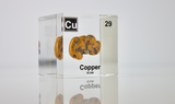 Clear acrylic cube showcasing copper element, including its name, atomic number 29, and properties as featured on the periodic table. Ideal for educational displays and collectors. 