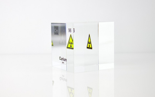 Clear acrylic cube displaying a Curium element (Atomic Number 96) embedded within, offering a scientific presentation for collectors and science enthusiasts.