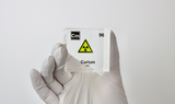 Clear acrylic cube displaying a Curium element (Atomic Number 96) embedded within, offering a scientific presentation for collectors and science enthusiasts.