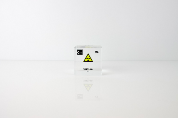 Clear acrylic cube displaying a Curium element (Atomic Number 96) embedded within, offering a scientific presentation for collectors and science enthusiasts.