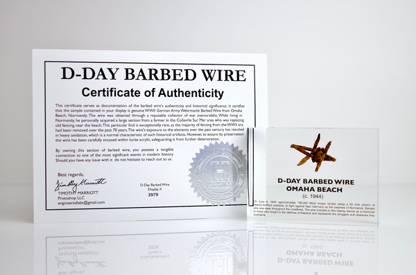 Clear acrylic display case featuring a historical fragment of D-Day barbed wire, offering an educational presentation for collectors and those interested in World War II history.