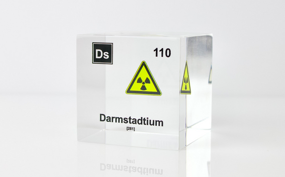 Clear acrylic cube displaying a Darmstadtium element (Atomic Number 110) embedded within, offering a scientific presentation for collectors and science enthusiasts.