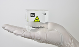 Clear acrylic cube displaying a Darmstadtium element (Atomic Number 110) embedded within, offering a scientific presentation for collectors and science enthusiasts.