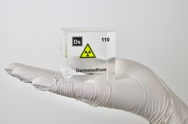 Clear acrylic cube displaying a Darmstadtium element (Atomic Number 110) embedded within, offering a scientific presentation for collectors and science enthusiasts.