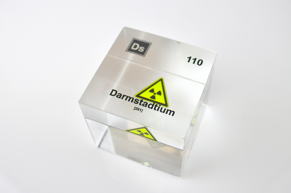 Clear acrylic cube displaying a Darmstadtium element (Atomic Number 110) embedded within, offering a scientific presentation for collectors and science enthusiasts.