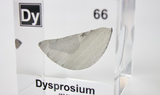 Clear acrylic cube displaying a Dysprosium element (Atomic Number 66) embedded within, offering a scientific presentation for collectors and science enthusiasts.
