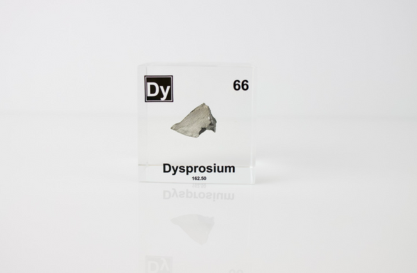 Clear acrylic cube displaying a Dysprosium element (Atomic Number 66) embedded within, offering a scientific presentation for collectors and science enthusiasts.