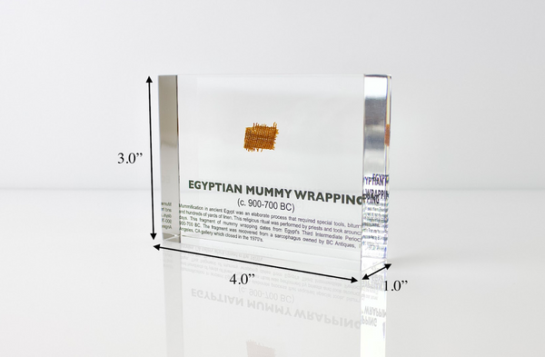 Clear acrylic display case featuring fragments of Egyptian mummy wrappings, offering a historical and educational presentation for collectors and those interested in ancient history.