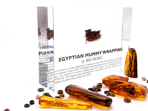Clear acrylic display case featuring fragments of Egyptian mummy wrappings, offering a historical and educational presentation for collectors and those interested in ancient history.