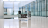 Clear acrylic cube displaying an Erbium element (Atomic Number 68) embedded within, offering a scientific presentation for collectors and science enthusiasts.