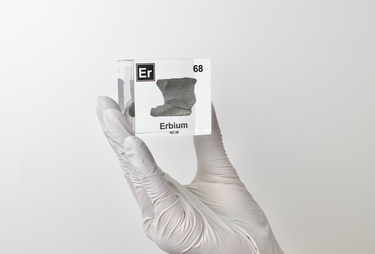 Clear acrylic cube displaying an Erbium element (Atomic Number 68) embedded within, offering a scientific presentation for collectors and science enthusiasts.