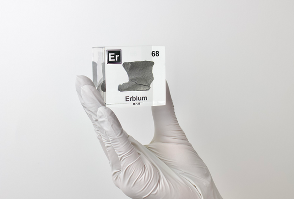 Clear acrylic cube displaying an Erbium element (Atomic Number 68) embedded within, offering a scientific presentation for collectors and science enthusiasts.