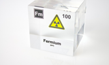 Clear acrylic cube displaying a Fermium element (Atomic Number 100) embedded within, offering a scientific presentation for collectors and science enthusiasts.