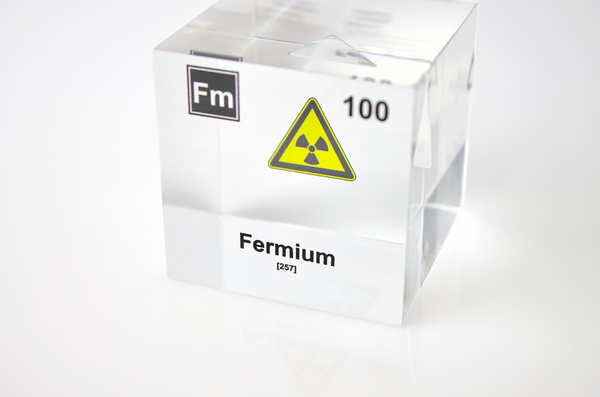 Clear acrylic cube displaying a Fermium element (Atomic Number 100) embedded within, offering a scientific presentation for collectors and science enthusiasts.