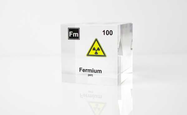 Clear acrylic cube displaying a Fermium element (Atomic Number 100) embedded within, offering a scientific presentation for collectors and science enthusiasts.