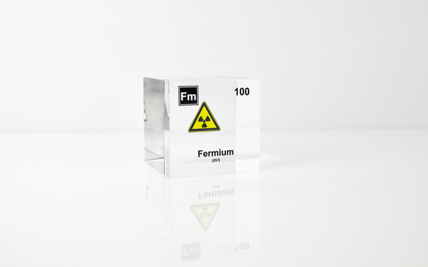 Clear acrylic cube displaying a Fermium element (Atomic Number 100) embedded within, offering a scientific presentation for collectors and science enthusiasts.