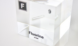 Clear acrylic cube encasing a Fluorine ampule with its atomic number 9. Ideal for display in educational settings, scientific collections, or as a decorative piece.