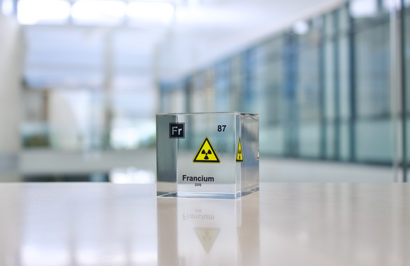 Clear acrylic cube displaying a Francium element (Atomic Number 87) embedded within, offering a scientific presentation for collectors and science enthusiasts.