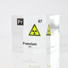 Clear acrylic cube displaying a Francium element (Atomic Number 87) embedded within, offering a scientific presentation for collectors and science enthusiasts.