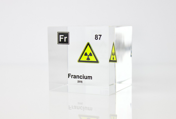 Clear acrylic cube displaying a Francium element (Atomic Number 87) embedded within, offering a scientific presentation for collectors and science enthusiasts.