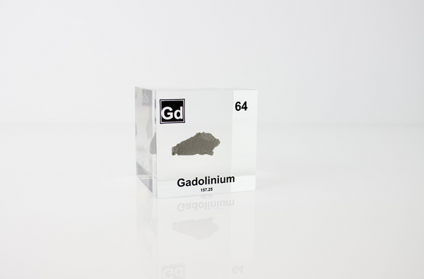 Clear acrylic cube displaying a Gadolinium element (Atomic Number 64) embedded within, offering a scientific presentation for collectors and science enthusiasts.