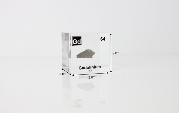 Clear acrylic cube displaying a Gadolinium element (Atomic Number 64) embedded within, offering a scientific presentation for collectors and science enthusiasts.