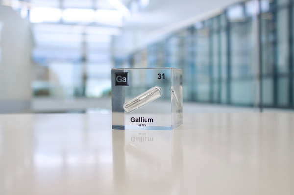 Gallium element encased in a clear acrylic cube, featuring its name, atomic number 31, and properties as displayed on the periodic table. Ideal for educational and collector use.