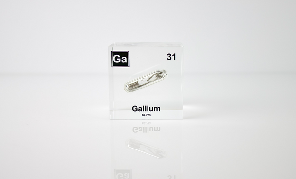 Gallium element encased in a clear acrylic cube, on a white background featuring its name, atomic number 31, and properties as displayed on the periodic table. Ideal for educational and collector use.