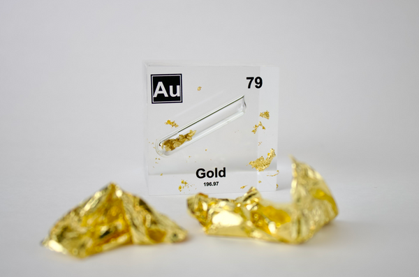 Clear acrylic cube displaying a Gold element (Atomic Number 79) embedded within, offering a scientific presentation for collectors and science enthusiasts.