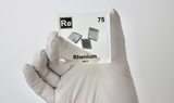 Rhenium element in a clear acrylic cube, featuring its name, atomic number, and properties as shown on the periodic table. A sleek and educational display for collectors and enthusiasts.