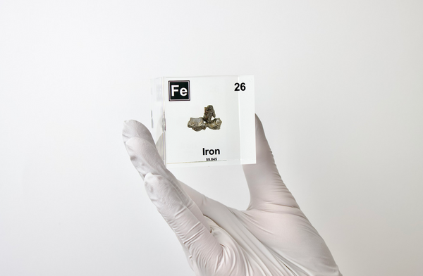 Iron element encased in a clear acrylic cube, featuring its name, atomic number, and key properties from the periodic table. A striking and educational display for science enthusiasts and collectors