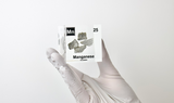 Manganese element held up in a clear acrylic cube, showcasing its name, atomic number, and properties as displayed on the periodic table. A stylish and informative piece for collectors and educators.
