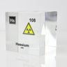Clear acrylic cube displaying a Hassium element (Atomic Number 108) embedded within, offering a scientific presentation for collectors and science enthusiasts.