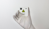 Clear acrylic cube displaying a Hassium element (Atomic Number 108) embedded within, offering a scientific presentation for collectors and science enthusiasts.