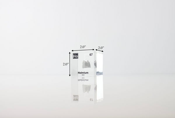 Clear acrylic cube displaying a Holmium element (Atomic Number 67) embedded within, offering a scientific presentation for collectors and science enthusiasts.