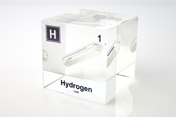 Clear acrylic cube displaying a Hydrogen element (Atomic Number 1) embedded within, offering a scientific presentation for collectors and science enthusiasts.