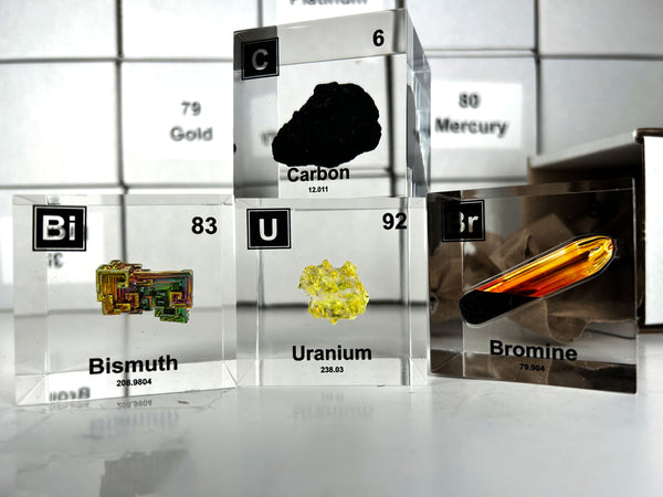 Carbon, bismuth, uranium, and bromine element cubes to build your personal atomic table of elements with our subscription.