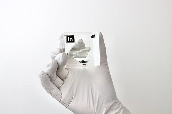 Clear acrylic cube displaying an Indium element (Atomic Number 49) embedded within, offering a scientific presentation for collectors and science enthusiasts.