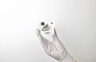 Clear acrylic cube displaying an Indium element (Atomic Number 49) embedded within, offering a scientific presentation for collectors and science enthusiasts.