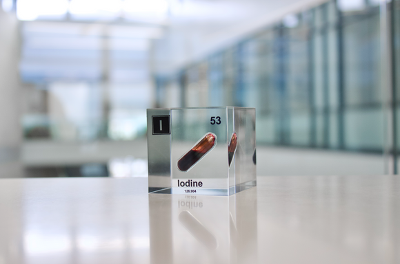 Clear acrylic cube displaying an Iodine element (Atomic Number 53) embedded within, offering a scientific presentation for collectors and science enthusiasts.