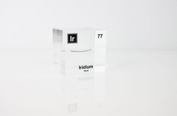 Piece of Iridium enclosed in a clear acrylic cube, featuring the element's name, atomic number, and key properties displayed as on the periodic table