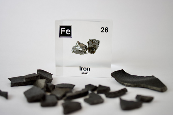 Iron element encased in a clear acrylic cube, featuring its name, atomic number, and key properties from the periodic table. A striking and educational display for science enthusiasts and collectors