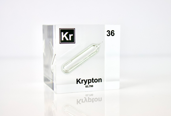 Clear acrylic cube displaying a Krypton element (Atomic Number 36) embedded within, offering a scientific presentation for collectors and science enthusiasts.