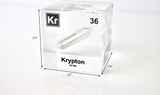 Clear acrylic cube displaying a Krypton element (Atomic Number 36) embedded within, offering a scientific presentation for collectors and science enthusiasts.