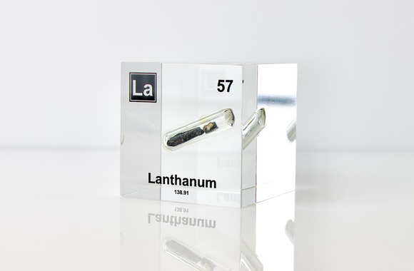 Clear acrylic cube displaying a Lanthanum element (Atomic Number 57) embedded within, offering a scientific presentation for collectors and science enthusiasts.